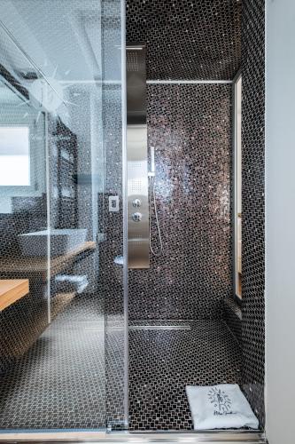 a bathroom with a shower with a glass door at Helios Guest House in Cagliari