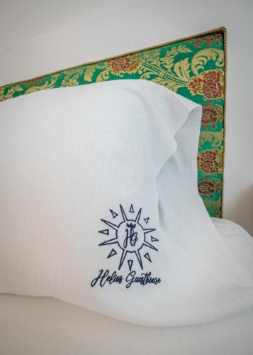 a pillow with a snowflake on it on a bed at Helios Guest House in Cagliari