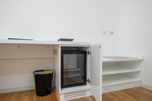 a white desk in a room with shelves at Helios Guest House in Cagliari