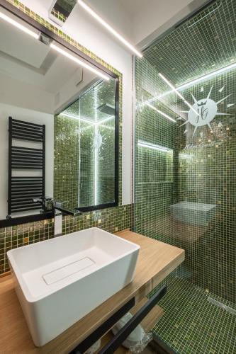 a bathroom with a white sink and a shower at Helios Guest House in Cagliari