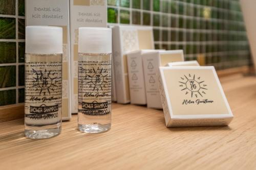 two bottles of sunscreen sitting on a table next to books at Helios Guest House in Cagliari