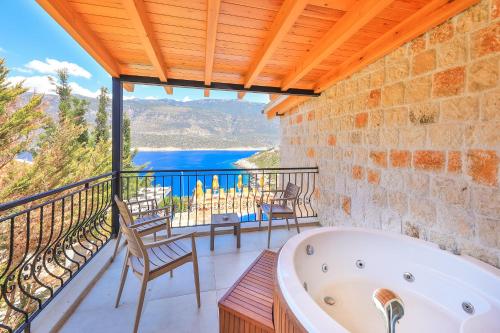 a bath tub in a room with a balcony at Atalante Hotel in Kas