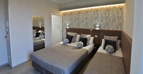 a large bedroom with two beds and a mirror at At your Place in Rome