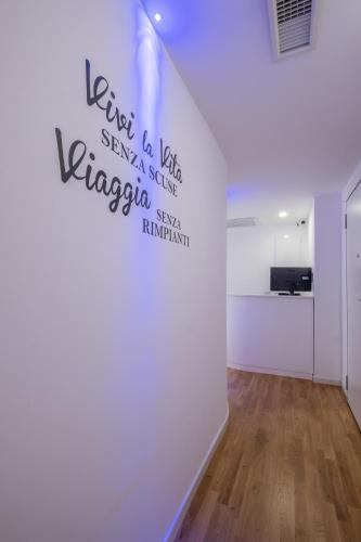 a room with a white wall with a heart on the wall at Helios Guest House in Cagliari