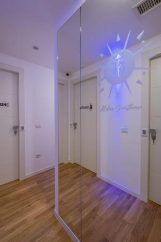 a glass wall in a room with two doors at Helios Guest House in Cagliari