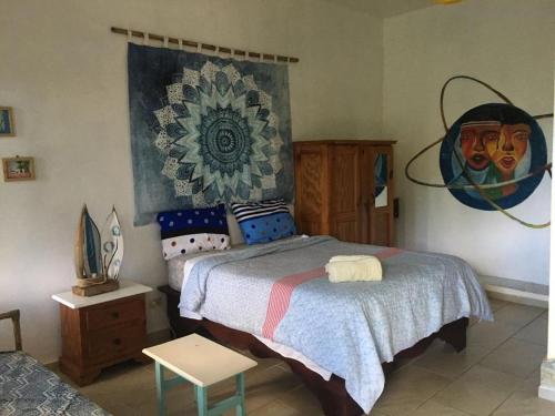 a bedroom with a bed and a painting on the wall at Villa Mar Sosua in Sosúa