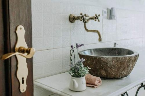 a bathroom with a bowl sink on a counter at Chalupa Skála 1827 in Skála