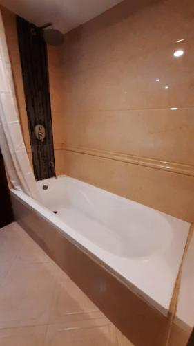 a white bath tub in a room with a shower at Hotel Bengal Canary Park in Dhaka
