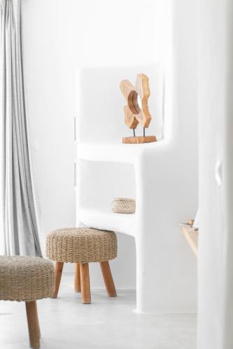 a table and two chairs in a white room at Irida Vacation suites in Kastraki Naxou