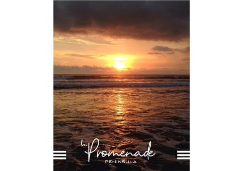 a picture of a sunset on the beach at Peninsula Dar Bouazza Superbe appartement en résidence avec piscine activités in Dar Bouazza