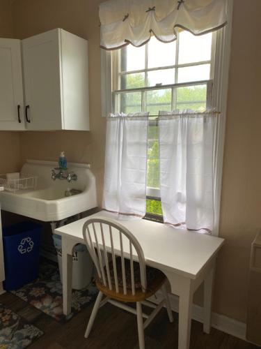 a kitchen with a sink and a chair and a window at Great Location! 4 Bedroom 2 bath sleeps 10 in Cape May