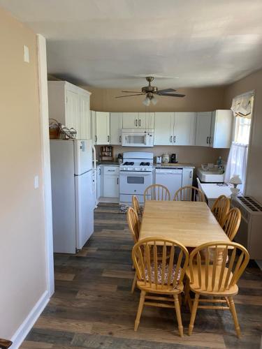 a kitchen with a table and chairs and white appliances at Great Location! 4 Bedroom 2 bath sleeps 10 in Cape May