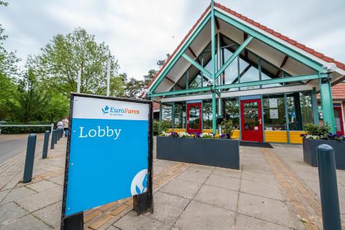 a sign in front of a flower shop at EuroParcs De Zanding in Otterlo