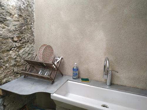 a sink with a chair and a bottle of water at Eco Yourte Lac du Bourget in Conjux