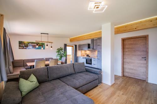 a living room with a couch and a table at Ferienwohnungen Jenewein in Gries am Brenner