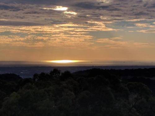 a view of the sun setting over the ocean at Sunset Hues -Enjoy Peace & Nature in Norton Summit
