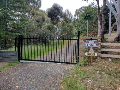 a black gate with a sign in front of it at Sunset Hues -Enjoy Peace & Nature in Norton Summit