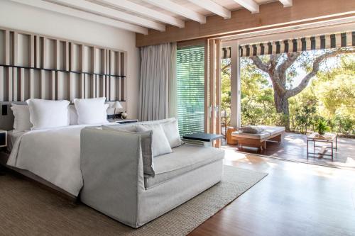 a bedroom with a bed and a couch at Four Seasons Astir Palace Hotel Athens in Athens