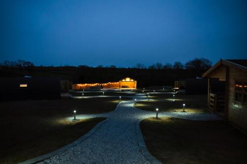 a garden at night with lights on the ground at Fulshaw Mill Holidays in Stewarton