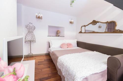 a room with two beds and a dresser in it at Romantic loft Porta Venezia MILAN in Milan