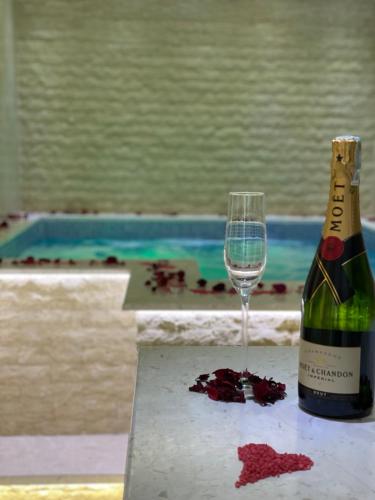 a bottle of wine and a wine glass on a table at Apartments Pericic in Sutomore