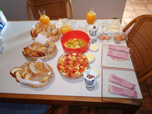 a table with a bunch of food on it at Maison Neuve Grandval in Grandval