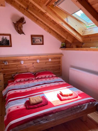 a bedroom with a large bed in a attic at Tara Place - Camp Rabrenovic in Mojkovac