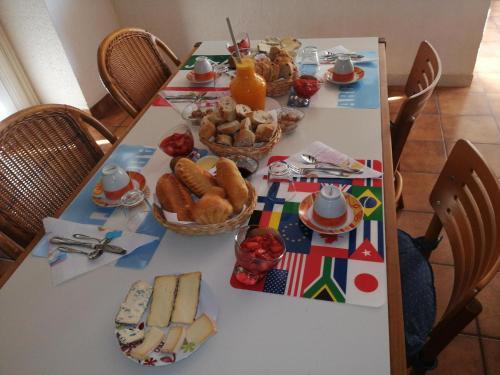 a table with food and baskets of food on it at Maison Neuve Grandval in Grandval