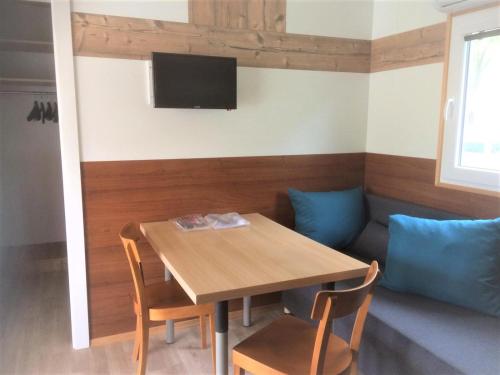 a dining room with a table and a couch at Polzer CAMPING BÜKFÜRDŐ in Bük