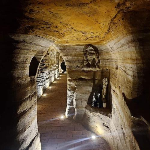 a hallway in an old stone building with lights at Vinný sklep a penzion U Bobule in Louka