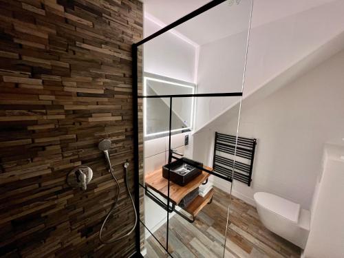 a bathroom with a glass shower and a toilet at LoveRoom By Gîtes d'Armor in Plélo
