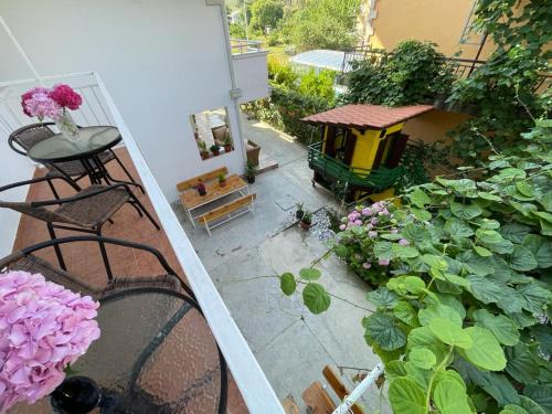 an overhead view of a balcony with flowers and a bird house at Apartments Pericic in Sutomore