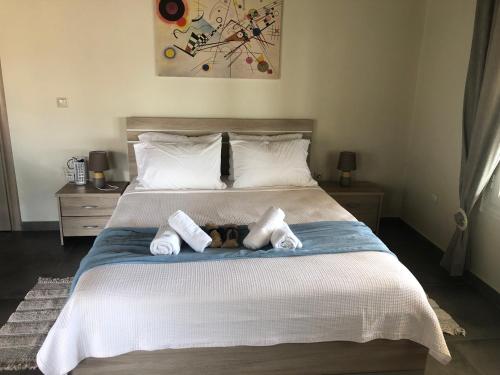 a bedroom with a bed with two stuffed animals on it at Thealassa in Kalliópi