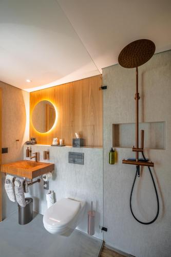 a bathroom with a sink and a toilet and a shower at Boutique Hotel La Gorge in Saas-Fee