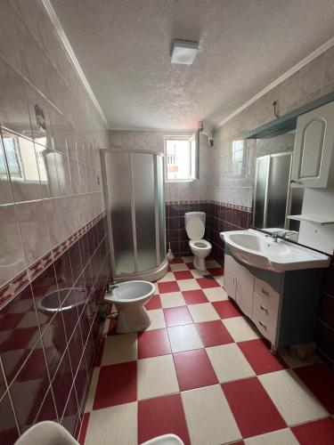 a bathroom with two toilets and a sink at Villa Ajša in Bar
