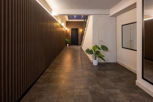 an office corridor with a dark wall and plants at The David Story Boutique in Jerusalem