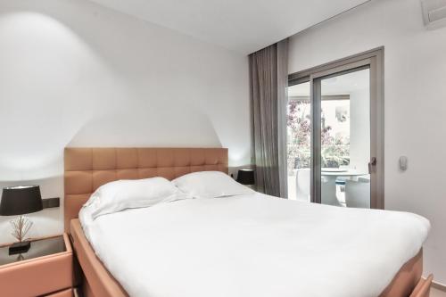 a bedroom with a large white bed and a window at Ancor 0-1 POOL VIEW 2B in Palm-Mar