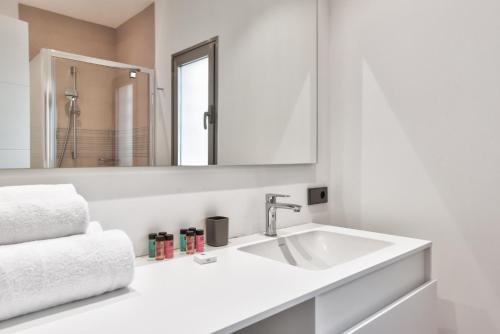 a white bathroom with a sink and a mirror at Ancor 0-1 POOL VIEW 2B in Palm-Mar