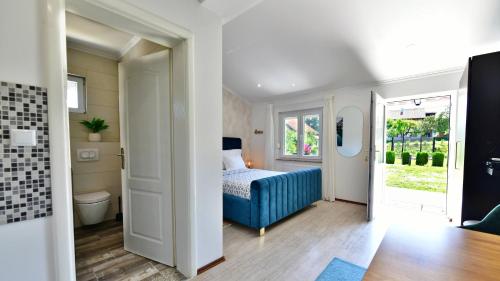 a bedroom with a blue bed and a window at Apartments Green Park in Rakovica