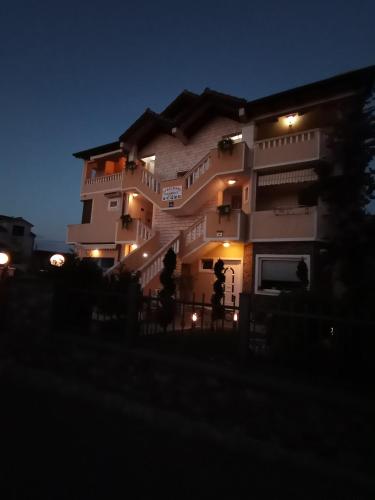 a large building at night with lights on at Apartments Ivanković in Stari Grad