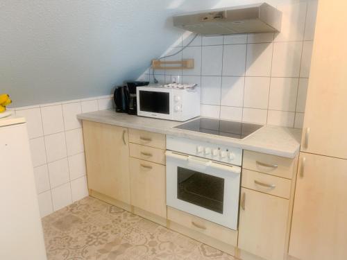 a kitchen with a stove and a microwave at Rooftop Corner Siófok in Siófok