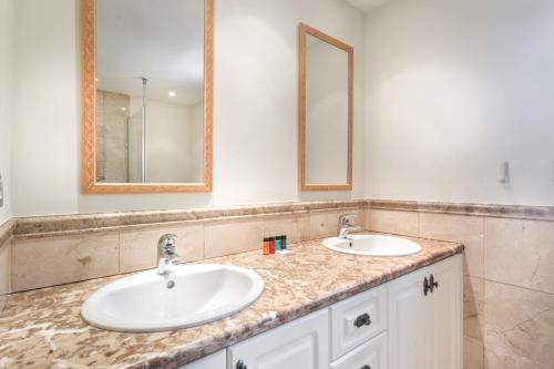 a bathroom with two sinks and two mirrors at Adjona 1-4 SEA VIEW 2B in Palm-mar