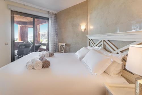 a bedroom with a bed with towels on it at Adjona 1-4 SEA VIEW 2B in Palm-mar
