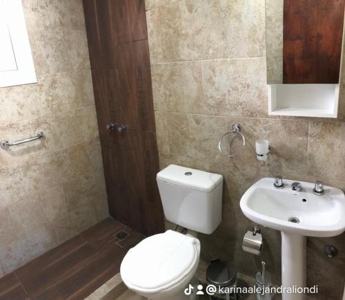 a bathroom with a toilet and a sink at Los Tres Algarrobos in Cortaderas