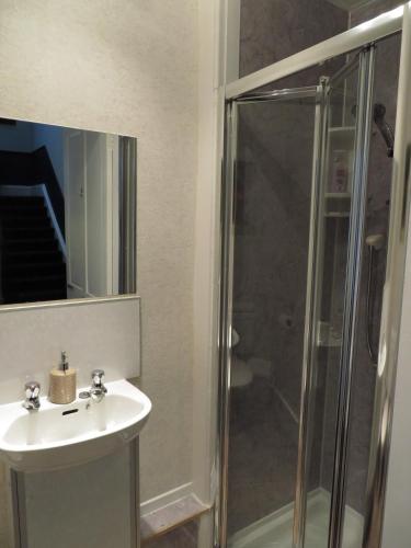 a bathroom with a sink and a shower at Parkhill Guest House in Inverness
