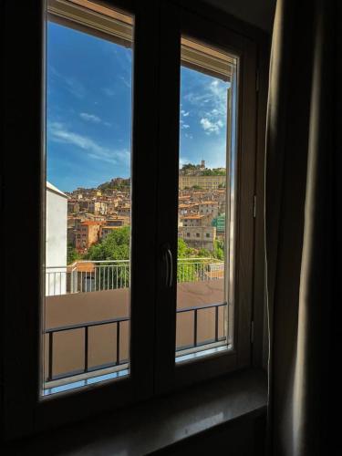 a window with a view of a city at De Novo e d'Antico in Cori