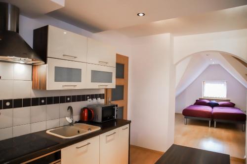 a kitchen with a purple couch in a room at Lovely apartment in city Center of Jelenia Gora. in Jelenia Góra