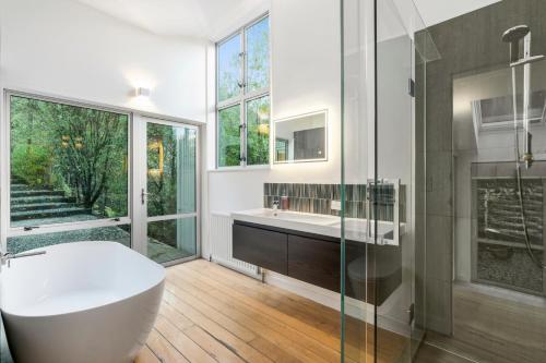 a bathroom with a tub and a sink at A Stunning Stay - Queenstown Holiday Home in Queenstown