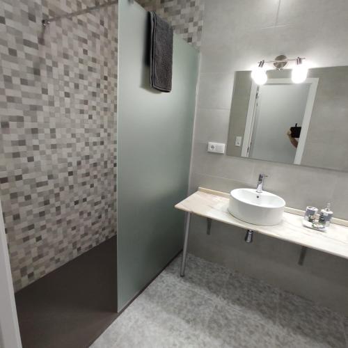 a bathroom with a sink and a mirror at Acogedor Alojamiento in Membrilla