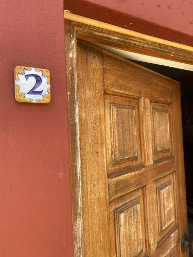 a door with the number two on the wall at Casa felix in Loulé